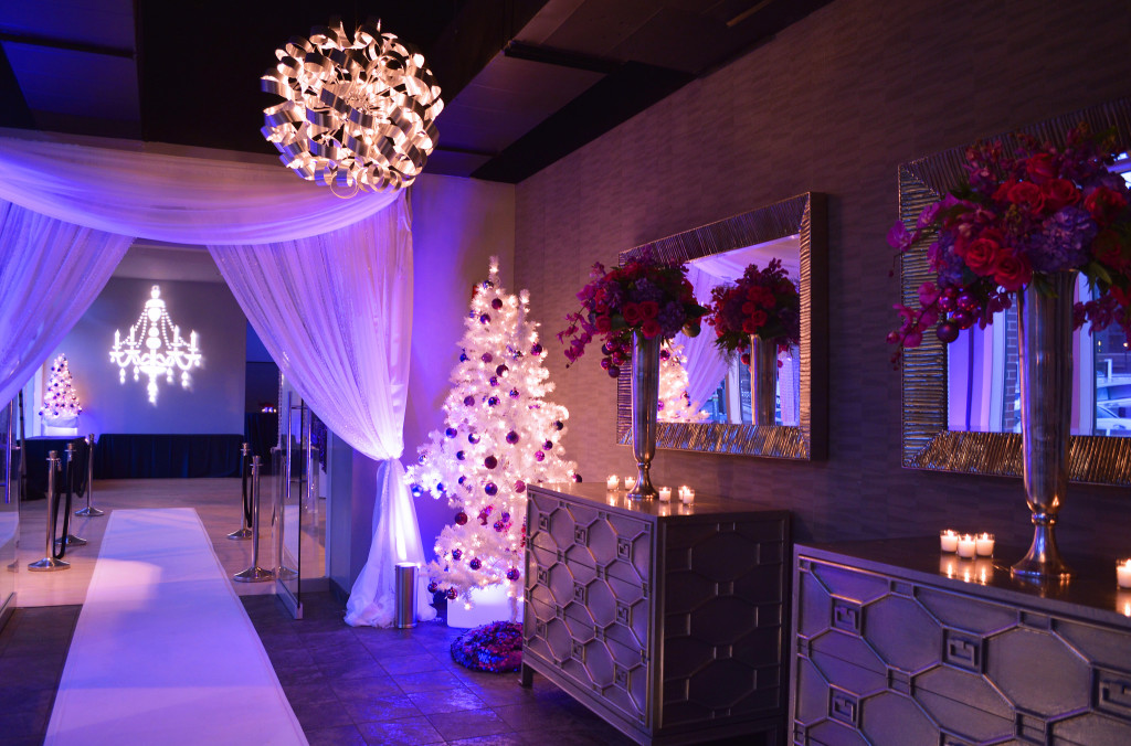 Chiffon draping frames the entrance to this event, with the sides cinched like curtains to create a wide entry.