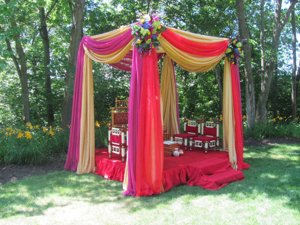 Draping to create canopy, mandap, or chuppah. Features traditional Indian color scheme of purple, gold and red.